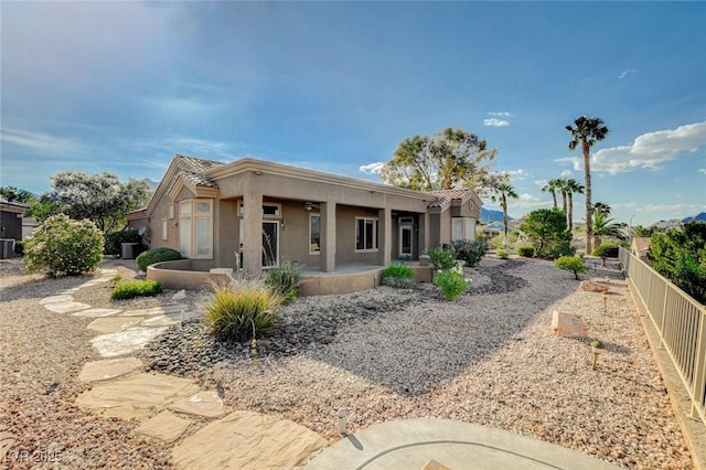 1904 Hot Oak Ridge St, Las Vegas, NV 89134 - view of front facade featuring stucco siding, a tiled roof, a fenced backyard, and a patio
