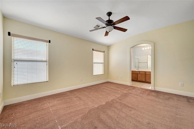 4841 Raw Umber Ct, Las Vegas, NV 89131 - unfurnished room featuring ceiling fan, light colored carpet, and arched walkways