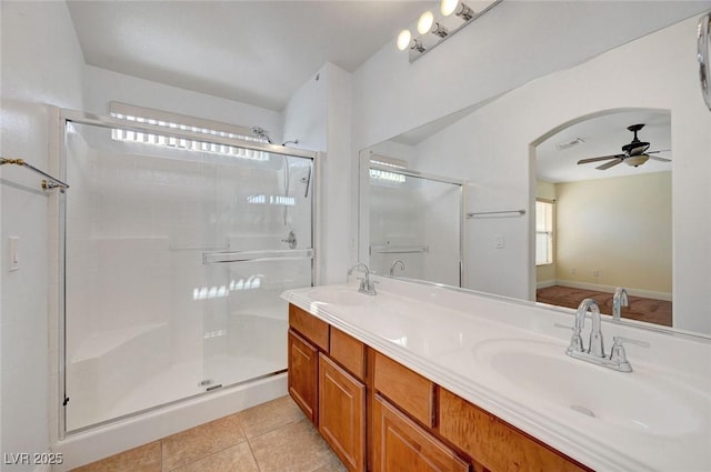 4841 Raw Umber Ct, Las Vegas, NV 89131 - bathroom with ceiling fan, a stall shower, tile patterned floors, and double vanity