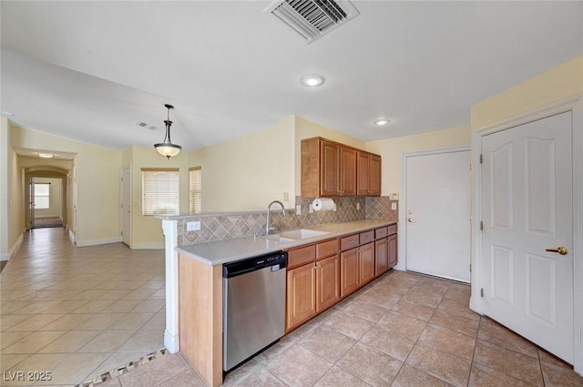 4841 Raw Umber Ct, Las Vegas, NV 89131 - kitchen with stainless steel dishwasher, light countertops, backsplash, light tile patterned floors, and hanging light fixtures