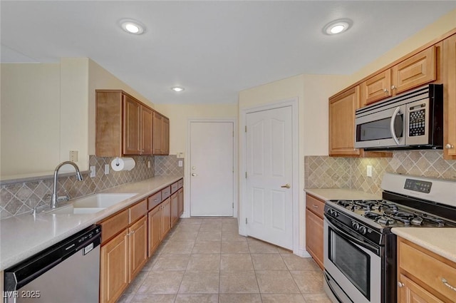4841 Raw Umber Ct, Las Vegas, NV 89131 - kitchen featuring stainless steel appliances, light countertops, backsplash, light tile patterned floors, and recessed lighting