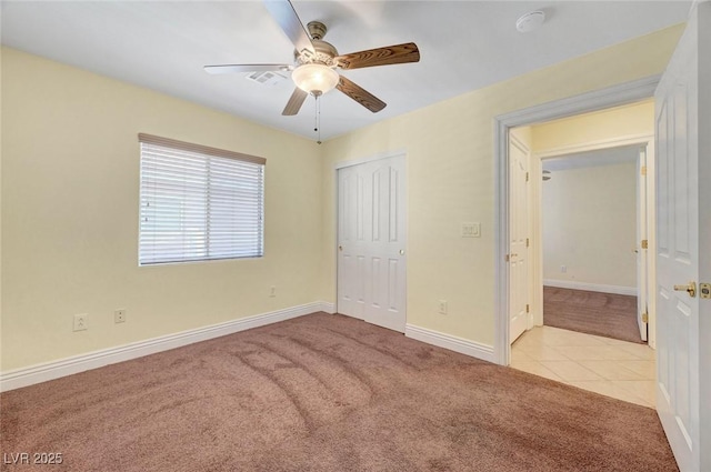 4841 Raw Umber Ct, Las Vegas, NV 89131 - unfurnished bedroom with carpet, a closet, tile patterned floors, and ceiling fan