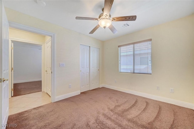 4841 Raw Umber Ct, Las Vegas, NV 89131 - unfurnished bedroom with light colored carpet, light tile patterned flooring, a closet, and ceiling fan