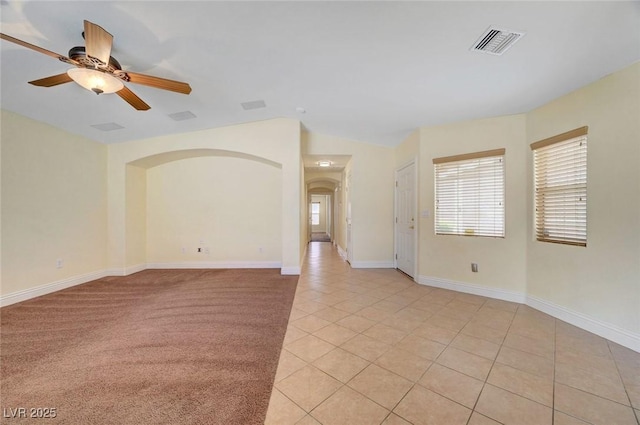 4841 Raw Umber Ct, Las Vegas, NV 89131 - spare room featuring light tile patterned floors, a ceiling fan, arched walkways, and lofted ceiling