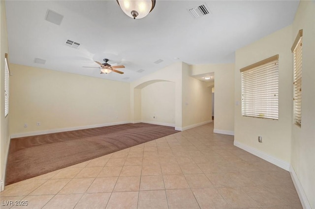 4841 Raw Umber Ct, Las Vegas, NV 89131 - spare room with a ceiling fan, light colored carpet, arched walkways, and light tile patterned floors