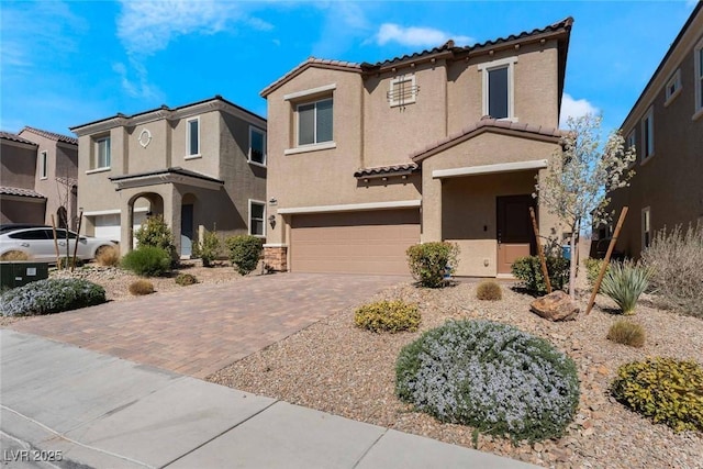 9850 Poplar Point Ave, Las Vegas, NV 89178 - view of front of property featuring a tile roof, a garage, stucco siding, and decorative driveway