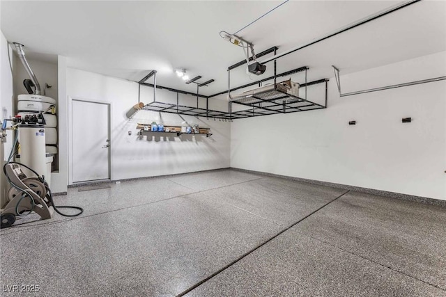 9850 Poplar Point Ave, Las Vegas, NV 89178 - garage with a garage door opener and baseboards