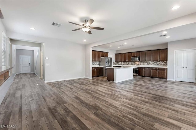 9850 Poplar Point Ave, Las Vegas, NV 89178 - unfurnished living room featuring ceiling fan, dark wood finished floors, and recessed lighting