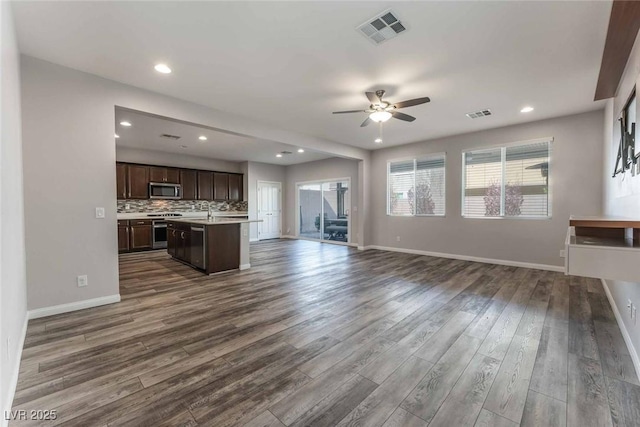 9850 Poplar Point Ave, Las Vegas, NV 89178 - unfurnished living room with ceiling fan, dark wood-style floors, and recessed lighting