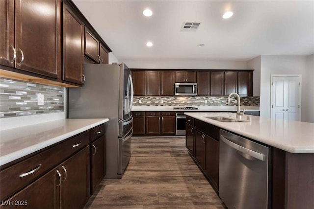 9850 Poplar Point Ave, Las Vegas, NV 89178 - kitchen featuring stainless steel appliances, dark wood-type flooring, light countertops, recessed lighting, and dark brown cabinetry