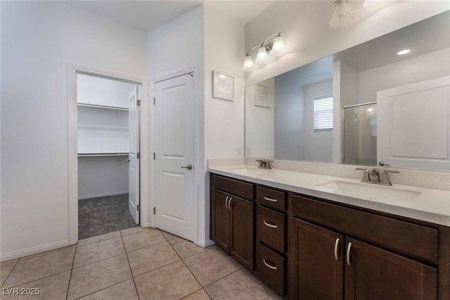 9850 Poplar Point Ave, Las Vegas, NV 89178 - bathroom with a stall shower, double vanity, a spacious closet, and tile patterned flooring