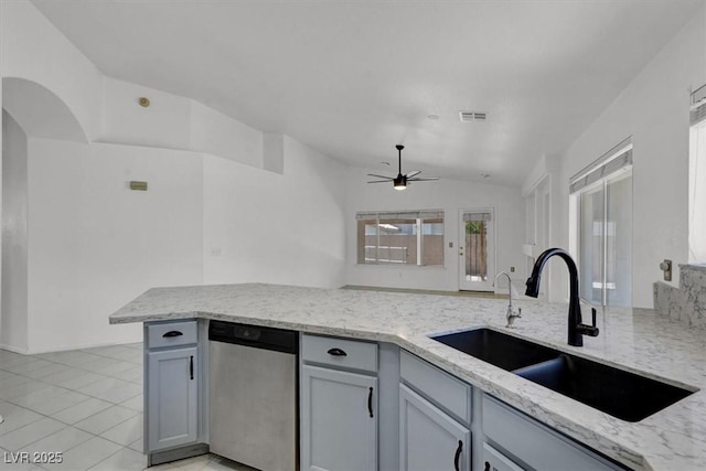 1613 Glenrosa Dr, North Las Vegas, NV 89031 - kitchen with stainless steel dishwasher, lofted ceiling, ceiling fan, light stone counters, and gray cabinets
