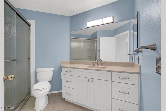 1613 Glenrosa Dr, North Las Vegas, NV 89031 - bathroom featuring a shower stall, vanity, and tile patterned flooring