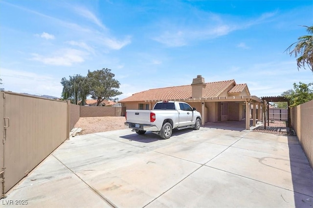 1613 Glenrosa Dr, North Las Vegas, NV 89031 - view of home's exterior featuring a tiled roof, stucco siding, a chimney, a pergola, and a patio