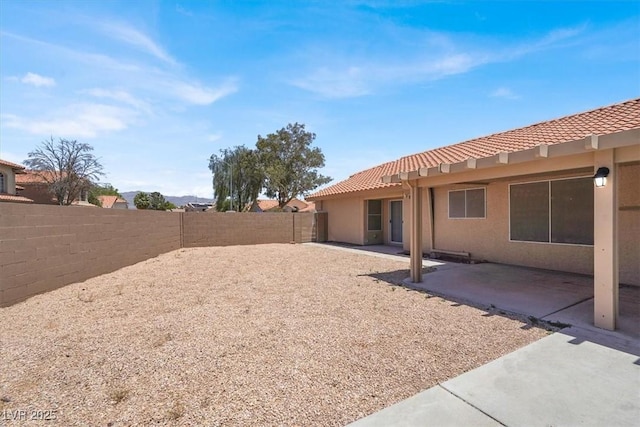 1613 Glenrosa Dr, North Las Vegas, NV 89031 - fenced backyard with a patio
