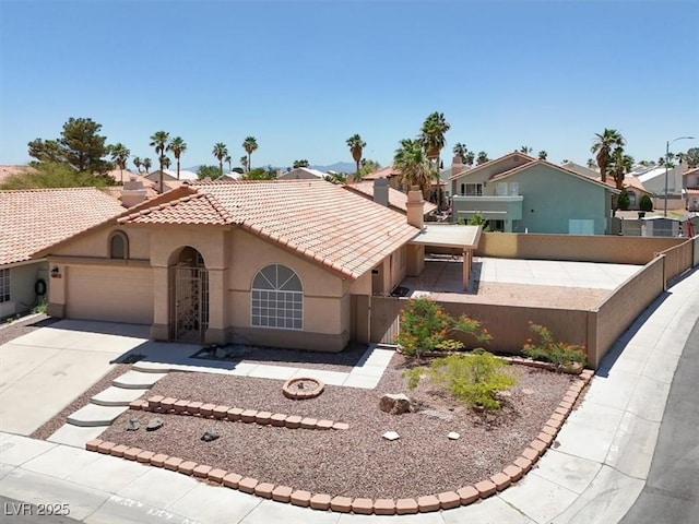 1613 Glenrosa Dr, North Las Vegas, NV 89031 - mediterranean / spanish-style house with stucco siding, an attached garage, driveway, a tiled roof, and a gate