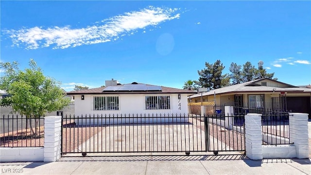 744 Hubbard St, Las Vegas, NV 89110 - bungalow-style house with solar panels, stucco siding, and a fenced front yard