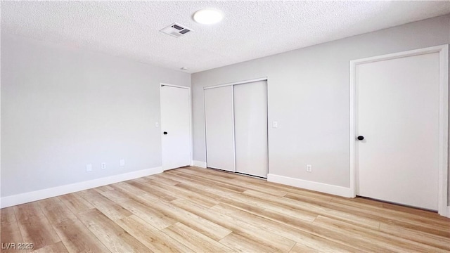 744 Hubbard St, Las Vegas, NV 89110 - unfurnished bedroom featuring light wood-style flooring and a textured ceiling
