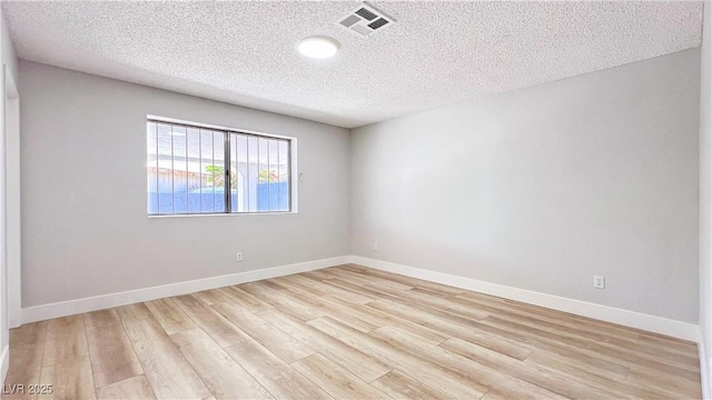 744 Hubbard St, Las Vegas, NV 89110 - unfurnished room featuring a textured ceiling and light wood-style floors