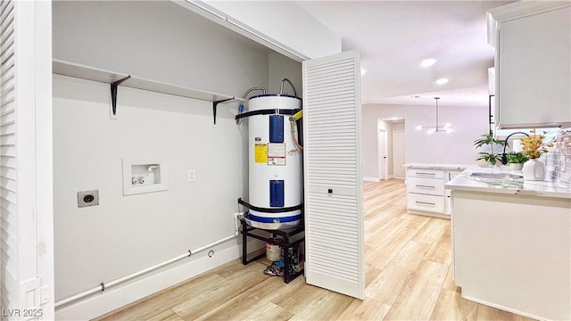744 Hubbard St, Las Vegas, NV 89110 - washroom with hookup for an electric dryer, hookup for a washing machine, light wood-style flooring, water heater, and recessed lighting