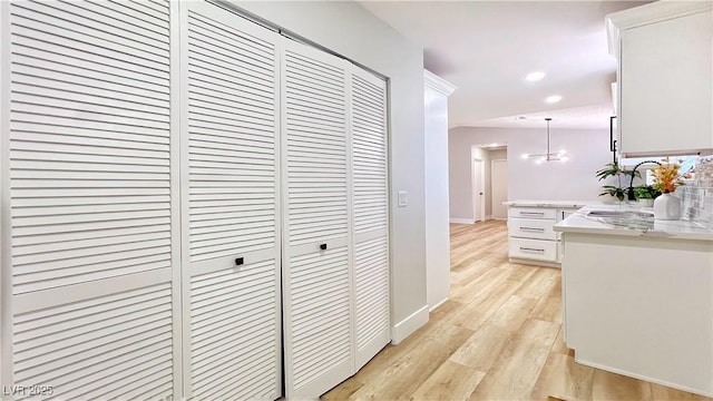 744 Hubbard St, Las Vegas, NV 89110 - corridor with light wood finished floors, a chandelier, and recessed lighting