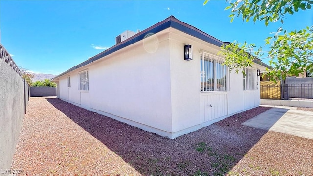 744 Hubbard St, Las Vegas, NV 89110 - view of side of home with a patio and stucco siding