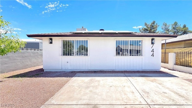 744 Hubbard St, Las Vegas, NV 89110 - rear view of house featuring roof mounted solar panels and a patio area