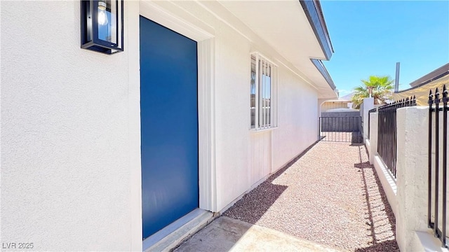 744 Hubbard St, Las Vegas, NV 89110 - view of home's exterior with stucco siding and a gate