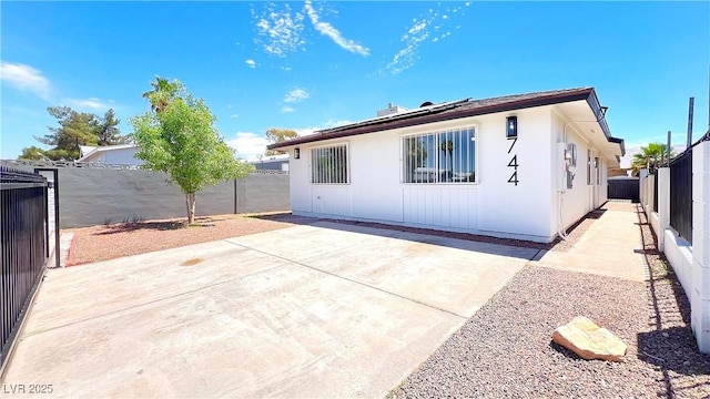 744 Hubbard St, Las Vegas, NV 89110 - rear view of property featuring a fenced backyard, roof mounted solar panels, and a patio