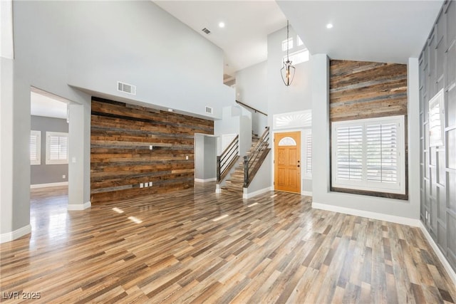 209 Camino Vista St, Henderson, NV 89012 - foyer with high vaulted ceiling, wood walls, stairway, light wood-style floors, and recessed lighting