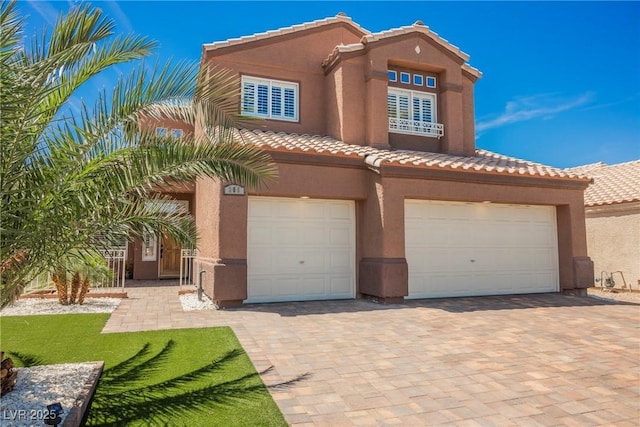 209 Camino Vista St, Henderson, NV 89012 - mediterranean / spanish-style house featuring a tile roof, a garage, stucco siding, and driveway