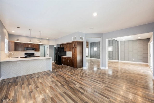 209 Camino Vista St, Henderson, NV 89012 - kitchen featuring open floor plan, black appliances, light countertops, wood finished floors, and recessed lighting
