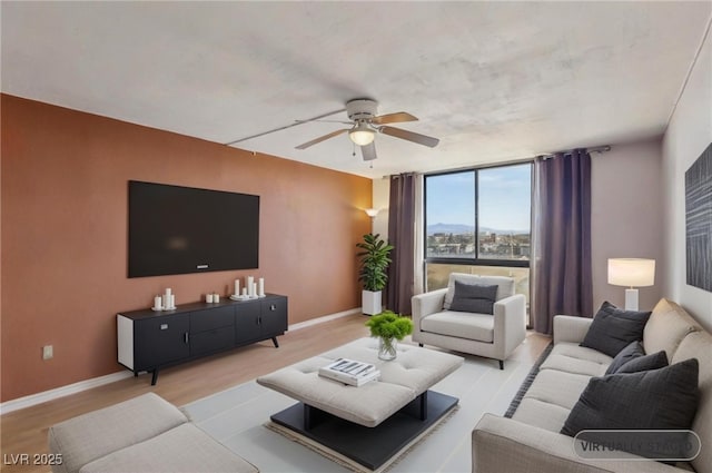 3930 University Center Dr Unit 804, Las Vegas, NV 89119 - living area with a ceiling fan, light wood-style flooring, and expansive windows