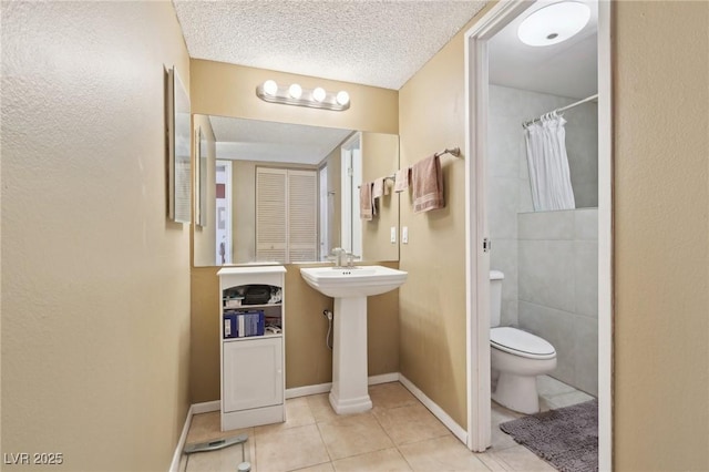 3930 University Center Dr Unit 804, Las Vegas, NV 89119 - bathroom with tile patterned floors, a shower with curtain, and a textured ceiling