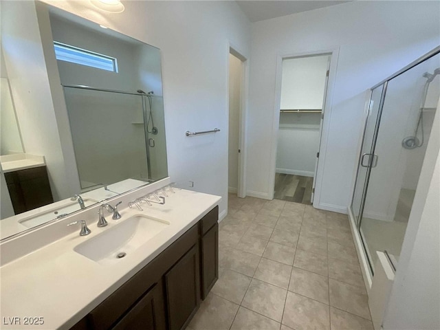 8550 Lost Pony St, Las Vegas, NV 89148 - full bathroom with a shower stall, vanity, a walk in closet, and tile patterned floors