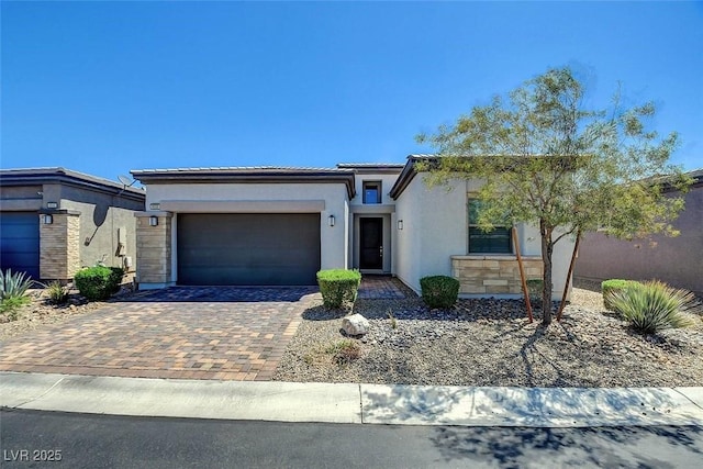 8550 Lost Pony St, Las Vegas, NV 89148 - view of front of house with an attached garage, decorative driveway, stucco siding, and a tiled roof