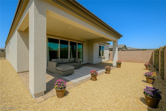 8550 Lost Pony St, Las Vegas, NV 89148 - rear view of house with a patio, stucco siding, a fenced backyard, and an outdoor hangout area