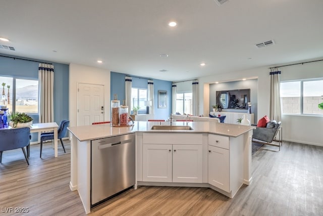 7965 Aurora Sky St Unit 623, North Las Vegas, NV 89084 - kitchen with stainless steel dishwasher, light wood-style floors, an island with sink, white cabinets, and recessed lighting