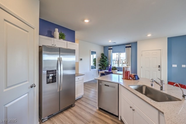 7965 Aurora Sky St Unit 623, North Las Vegas, NV 89084 - kitchen with stainless steel appliances, white cabinetry, light wood finished floors, recessed lighting, and light stone counters