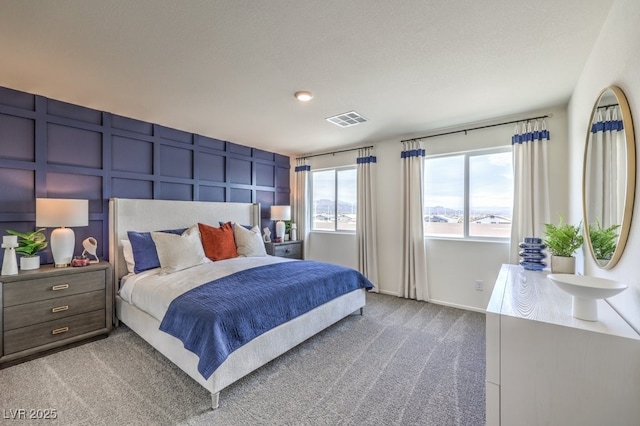 7965 Aurora Sky St Unit 623, North Las Vegas, NV 89084 - bedroom featuring carpet and a decorative wall