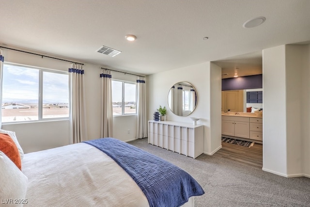 7965 Aurora Sky St Unit 623, North Las Vegas, NV 89084 - carpeted bedroom with baseboards and ensuite bath