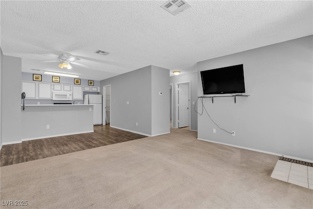2124 Willowbury Dr Unit D, Las Vegas, NV 89108 - unfurnished living room with ceiling fan, dark colored carpet, and a textured ceiling