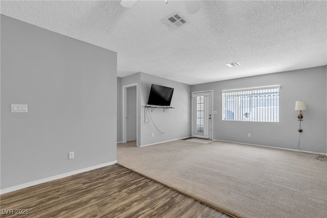 2124 Willowbury Dr Unit D, Las Vegas, NV 89108 - unfurnished living room with ceiling fan, wood finished floors, a textured ceiling, and carpet floors