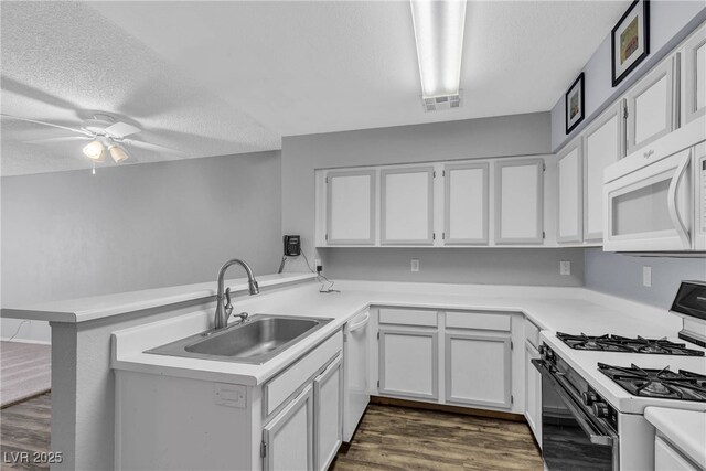 2124 Willowbury Dr Unit D, Las Vegas, NV 89108 - kitchen with white appliances, a peninsula, a textured ceiling, a ceiling fan, and light countertops