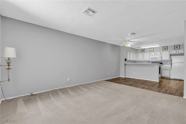 2124 Willowbury Dr Unit D, Las Vegas, NV 89108 - unfurnished living room with dark colored carpet, ceiling fan, and a textured ceiling
