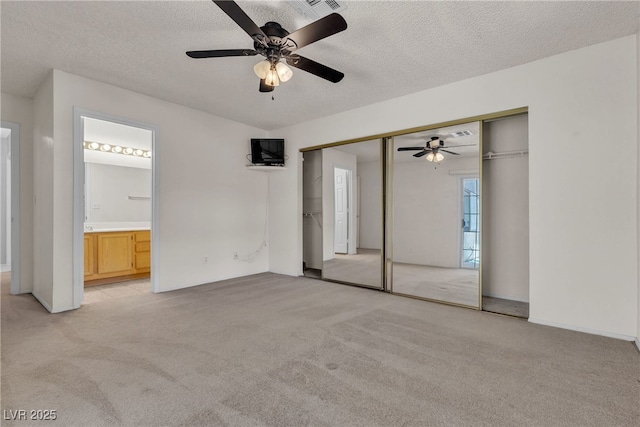 2124 Willowbury Dr Unit D, Las Vegas, NV 89108 - unfurnished bedroom featuring light colored carpet, a closet, a textured ceiling, ensuite bathroom, and a ceiling fan