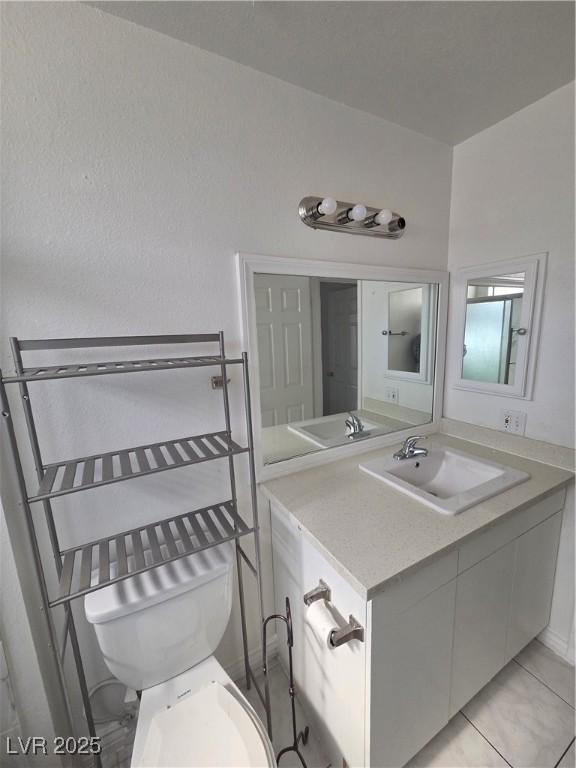 6402 Agua Dr, Las Vegas, NV 89103 - half bath featuring vanity and tile patterned flooring