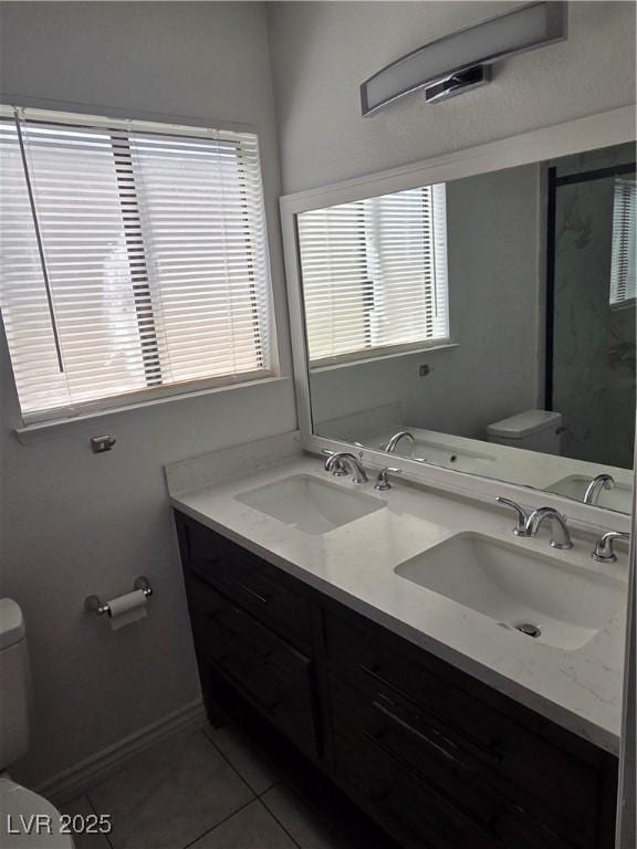6402 Agua Dr, Las Vegas, NV 89103 - full bath with tile patterned floors, a stall shower, and double vanity