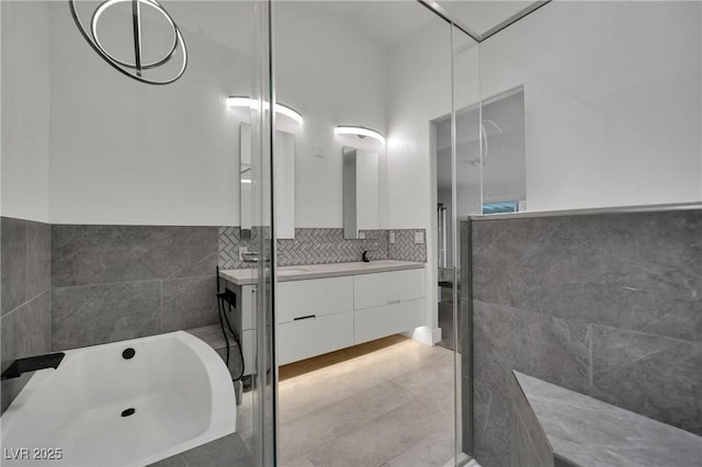 9180 Mohawk St, Las Vegas, NV 89139 - bathroom featuring vanity, a bath, tile patterned floors, and tile walls
