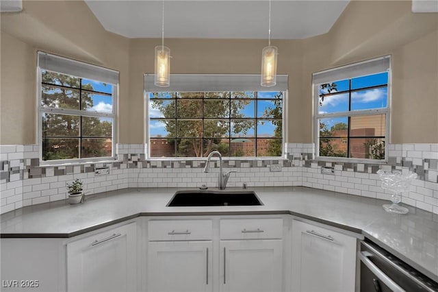 9180 Mohawk St, Las Vegas, NV 89139 - kitchen featuring decorative backsplash, light countertops, and white cabinetry